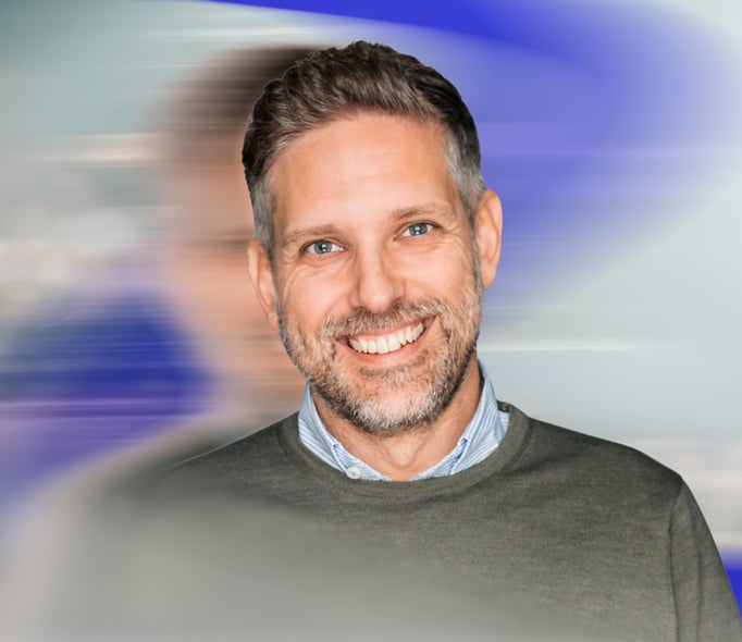 Portrait of Henrik Segergren, Country Director Sweden at iO, smiling against a light abstract background in blue and grey tones.