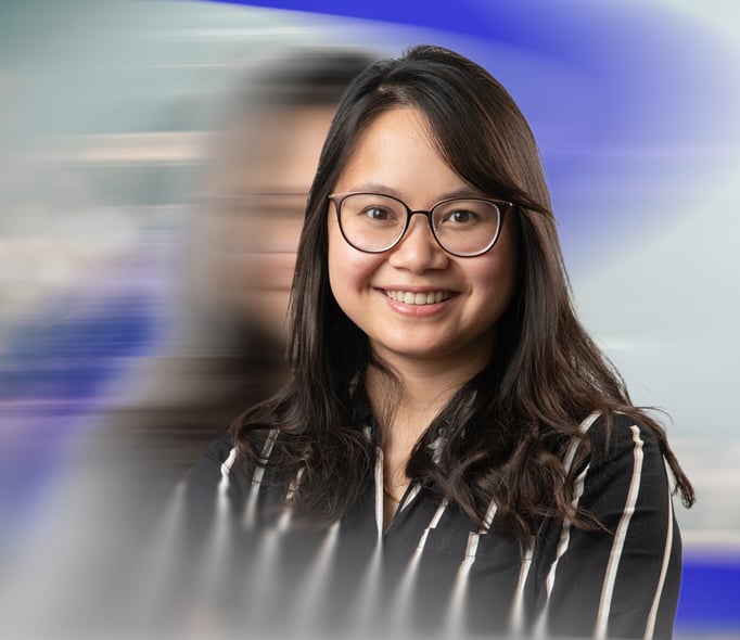 Ngoc Nhu Quan Nguyen smiling against a light abstract background in blue and grey tones.
